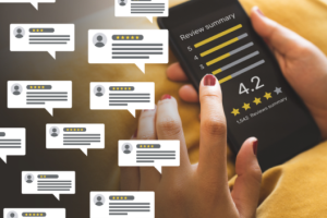 Person holding a phone that shows a review summary with a 4.2 rating; many white speech-bubble comments float in the background.